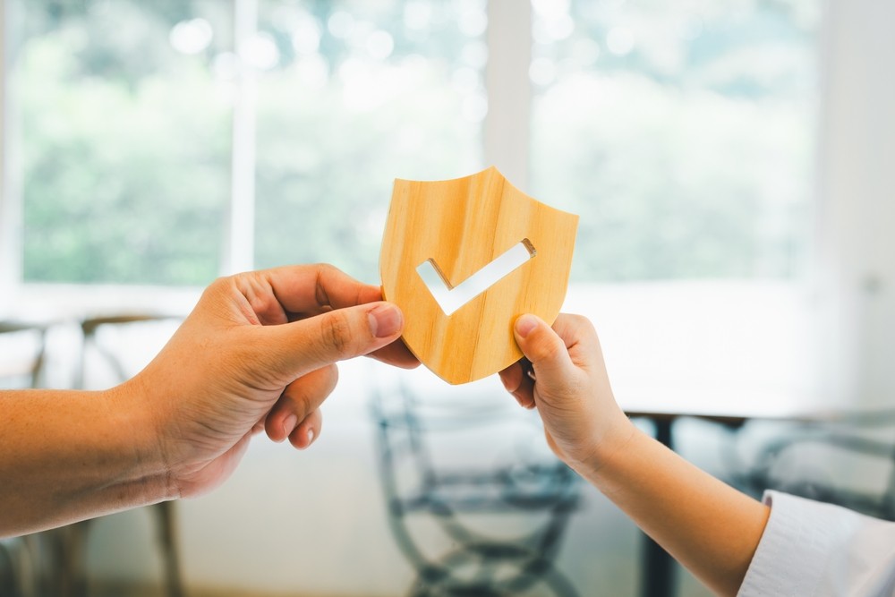 Adult hands off a check mark symbol to a child